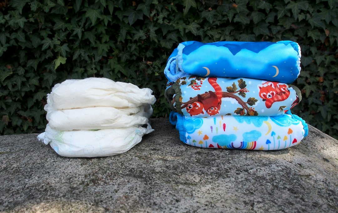 A disposable diaper laid beside a reusable cloth diaper for comparison (adult diapers)