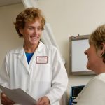 A doctor talking with an adult patient during a consultation