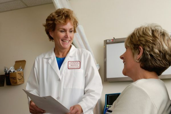 A doctor talking with an adult patient during a consultation