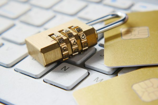 A golden padlock sitting on a computer keyboard, representing online privacy