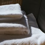 A stack of fluffy white towels in morning light