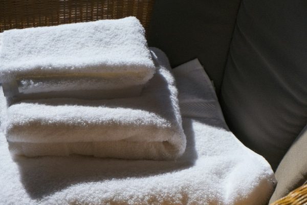 A stack of fluffy white towels in morning light