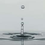 A single drop of water falling into still water