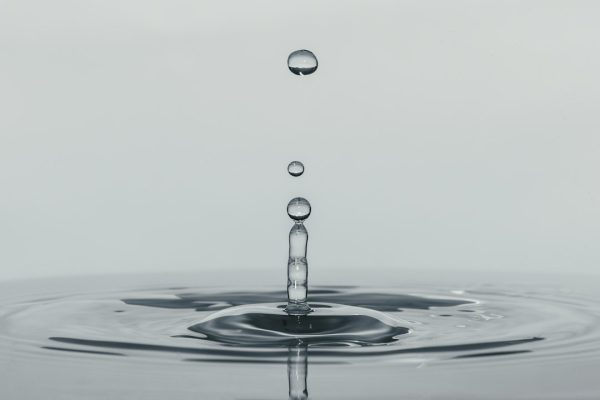 A single drop of water falling into still water