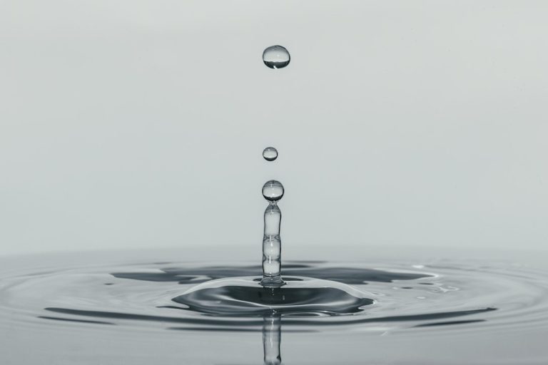 A single drop of water falling into still water