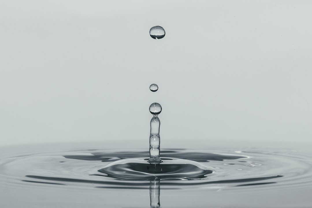 A single drop of water falling into still water