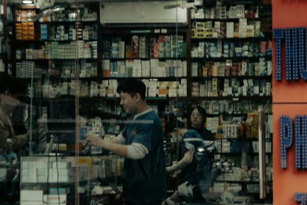 Shoppers inside a well-stocked pharmacy